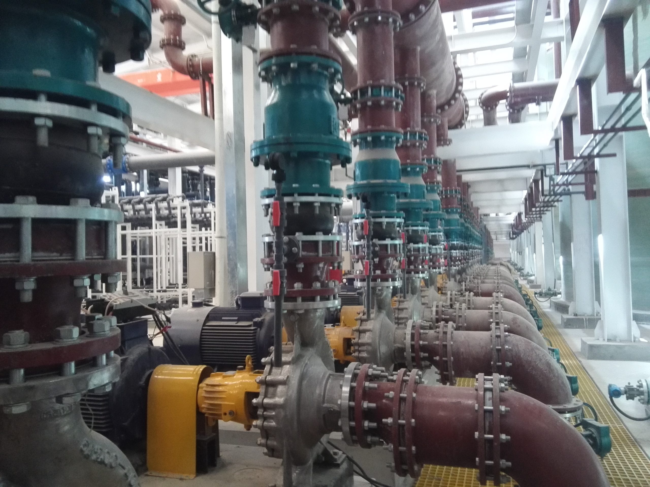 Rubber expansion joints installed at multiple pump connections in a mechanical room